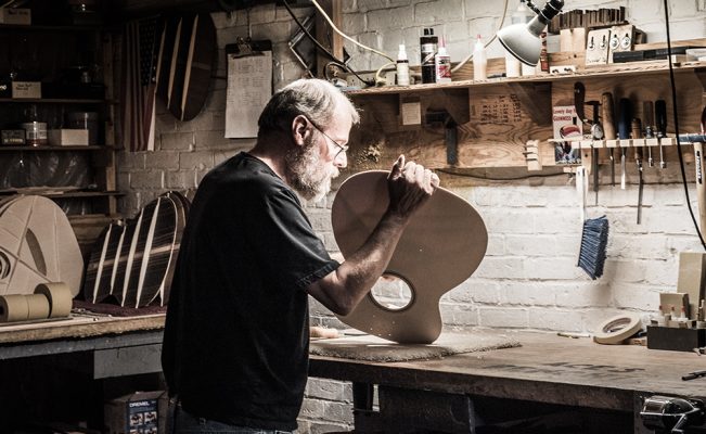 dana bourgeois in his shop building high quality guitars